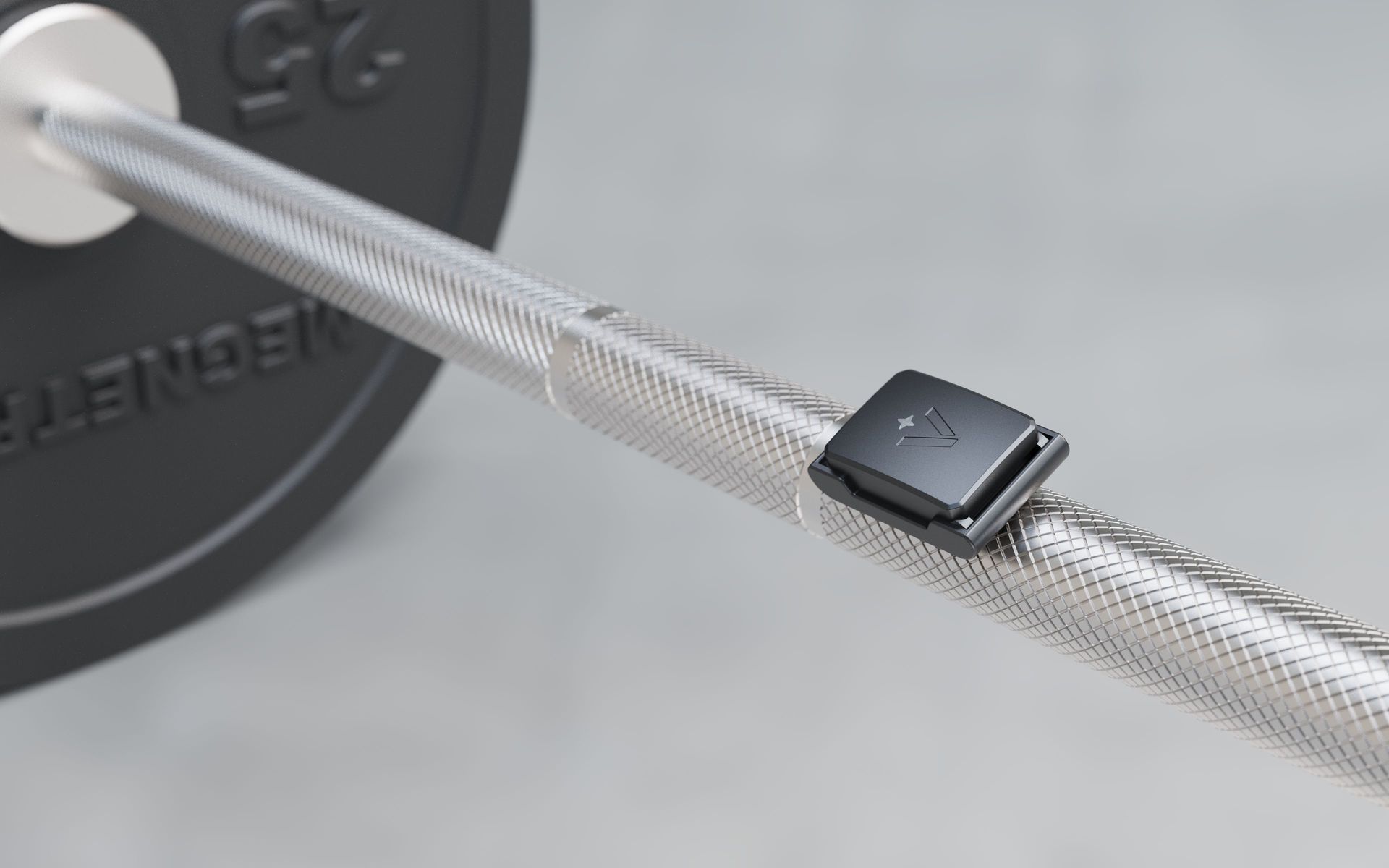 The Velocity sensor clipped to a loaded barbell