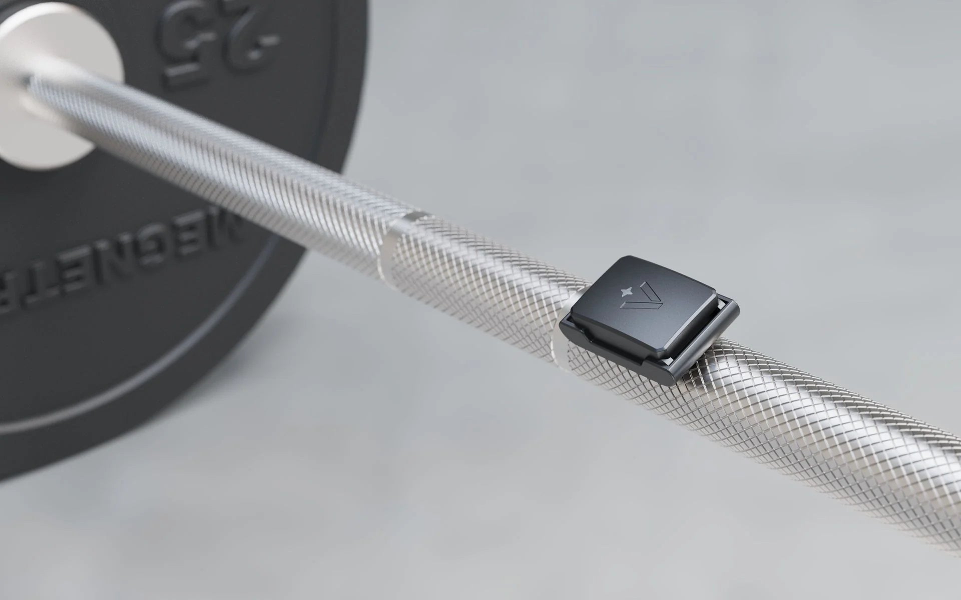 The Velocity sensor clipped to a loaded barbell